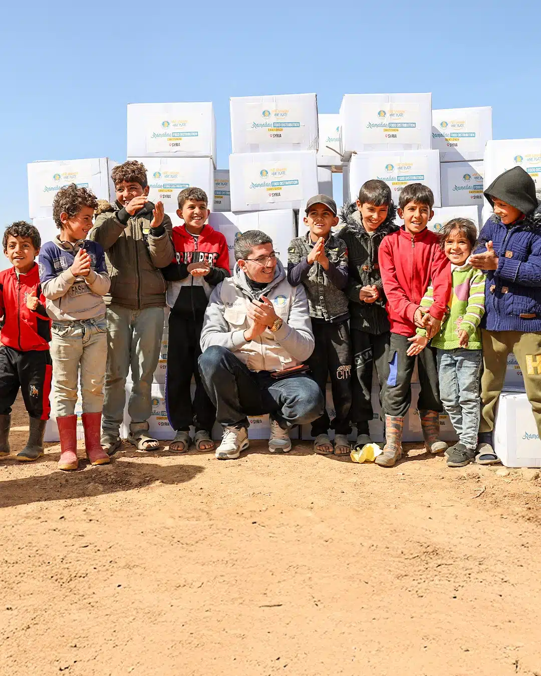 Charity Week campaign — volunteers and children with relief supplies